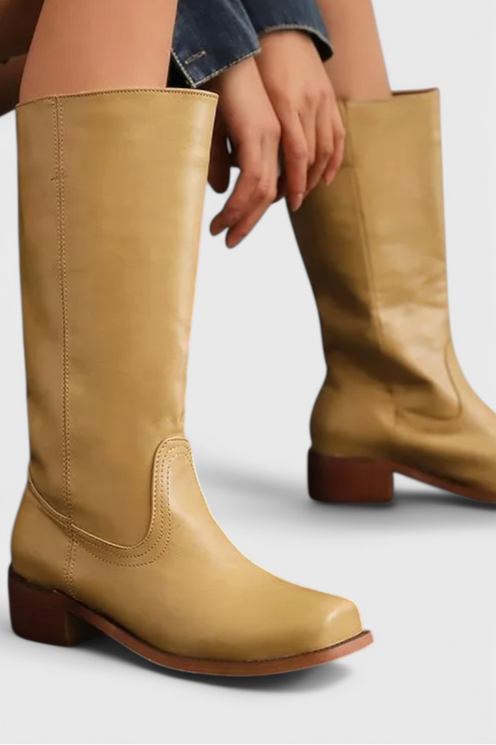Classic ladies' knee-high leather boots with comfortable heel, offering versatile style.