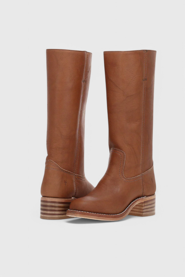 Stylish women's slip-on knee-high boots with elegant heel, perfect for winter chic.