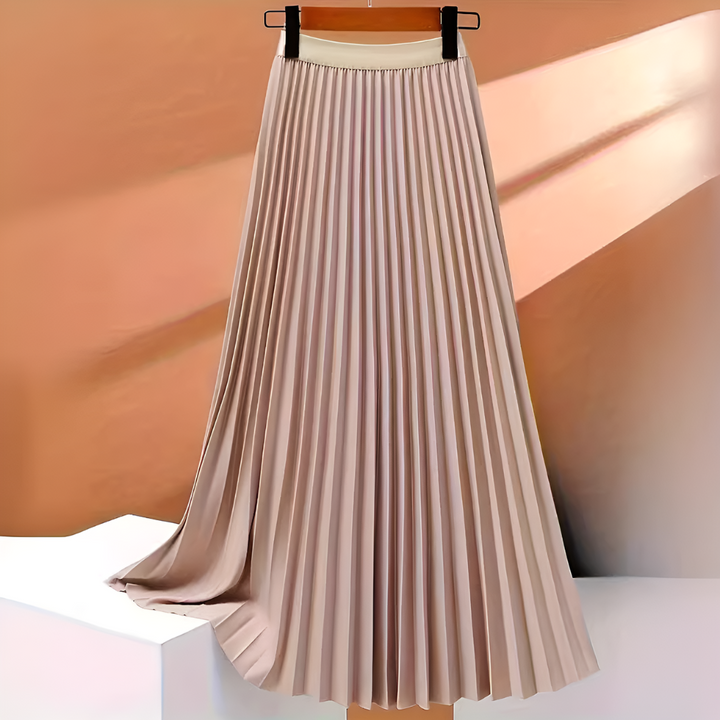 Woman wearing a flowing high-waist pleated black midi skirt, displaying its elegant movement and fit.