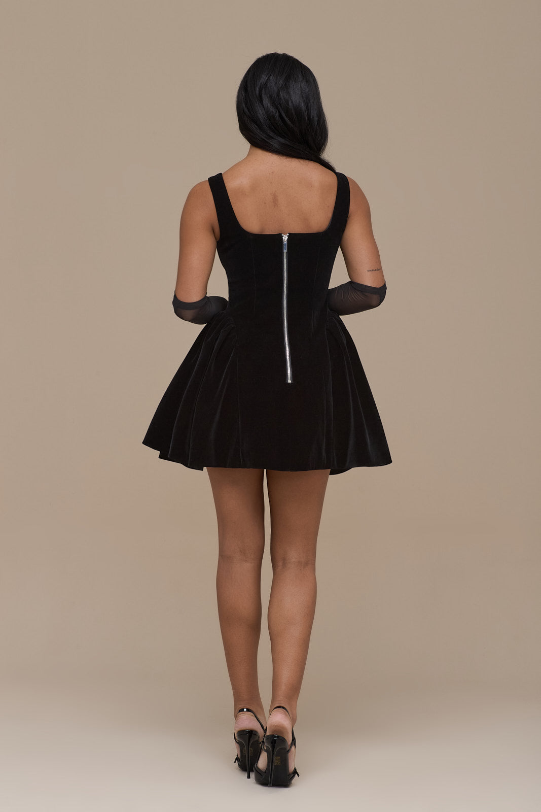 Versatile black cocktail mini dress in luxurious velvet, featuring a stylish fit & flare silhouette.