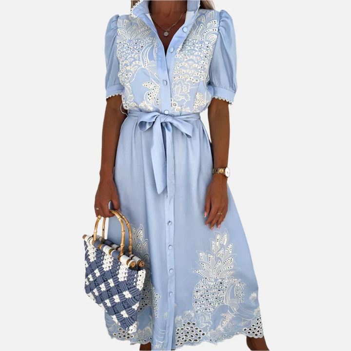Stylish women's blue A-line dress featuring delicate floral embroidery, a versatile choice for elegant spring & summer looks.
