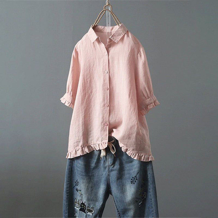 Chic women's button-down blouse featuring a trendy ruffled hem, an ideal elegant ladies shirt for versatile styling.