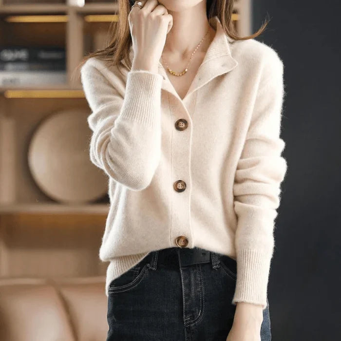 Close-up of a women's cozy knit cardigan, featuring delicate buttons & a sophisticated stand-collar. Ideal for winter.