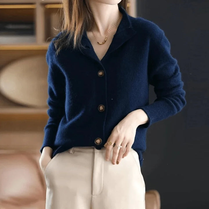 Woman wearing a fashionable button-front knit cardigan. Stand-collar design adds elegance. Great for layering in cool weather.