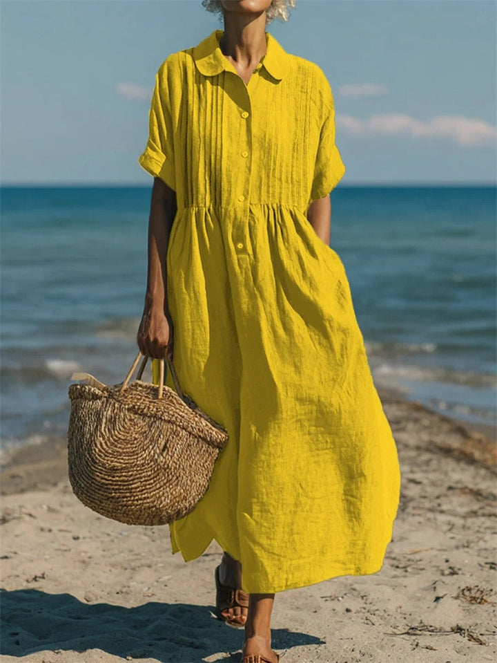Relaxed fit women's summer midi dress, collared & buttoned, offering comfort & elegant style.