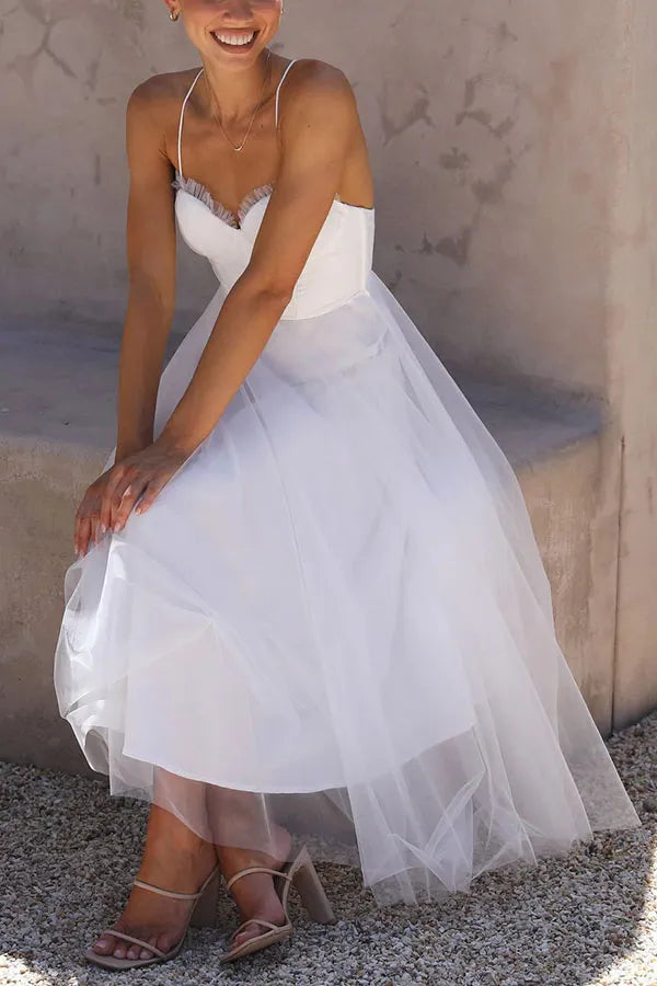 Elegant women's strappy midi dress with a beautiful corset bodice & flowing layered skirt for special occasions.