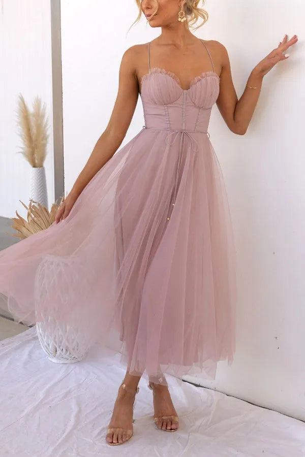 Women's occasion midi dress with a stylish corset bodice and a flowing, layered skirt detail.