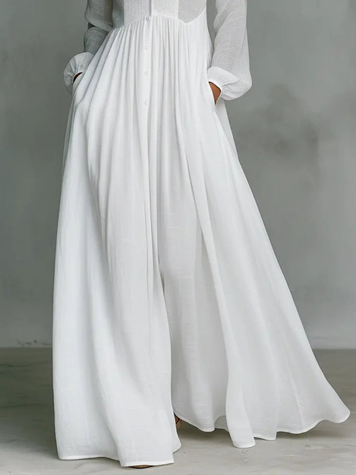 Spring/Summer women's flowy maxi dress. Elegant stand collar, button-front, and subtle patchwork on cotton linen.