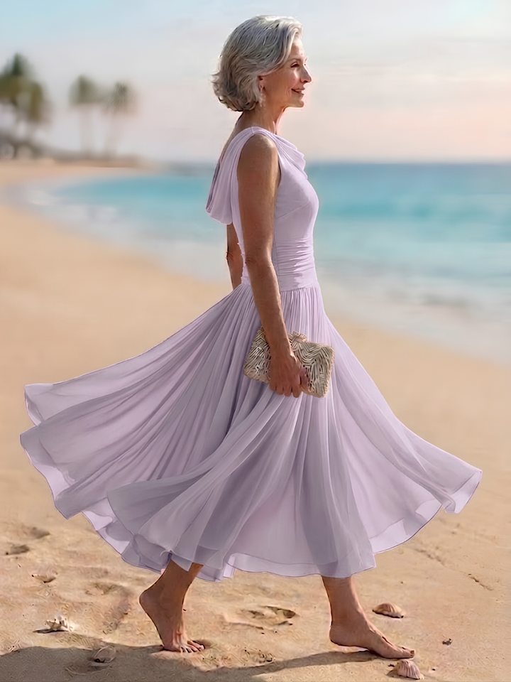 Women's elegant A-line midi dress with draped neck, sleeveless cut, and beautiful pleated details.