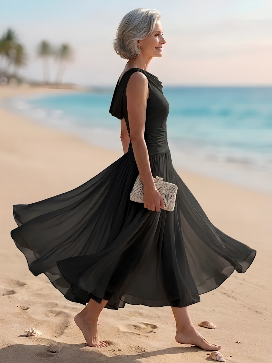 Chic women's sleeveless A-line midi dress. Draped neck and pleated design make it perfect for wedding guest or party.