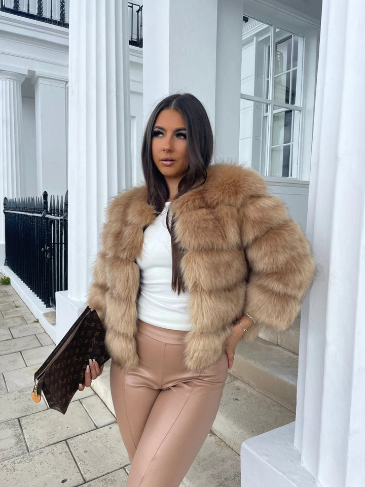 Warm women's elegant faux fur outerwear, ideal for chic cold days.
