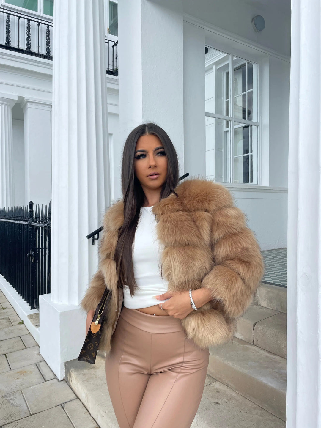 Fashionable women's faux fur jacket, offering luxurious winter style.