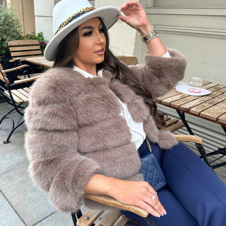 Chic women's faux fur coat, a glamorous choice for winter elegance.