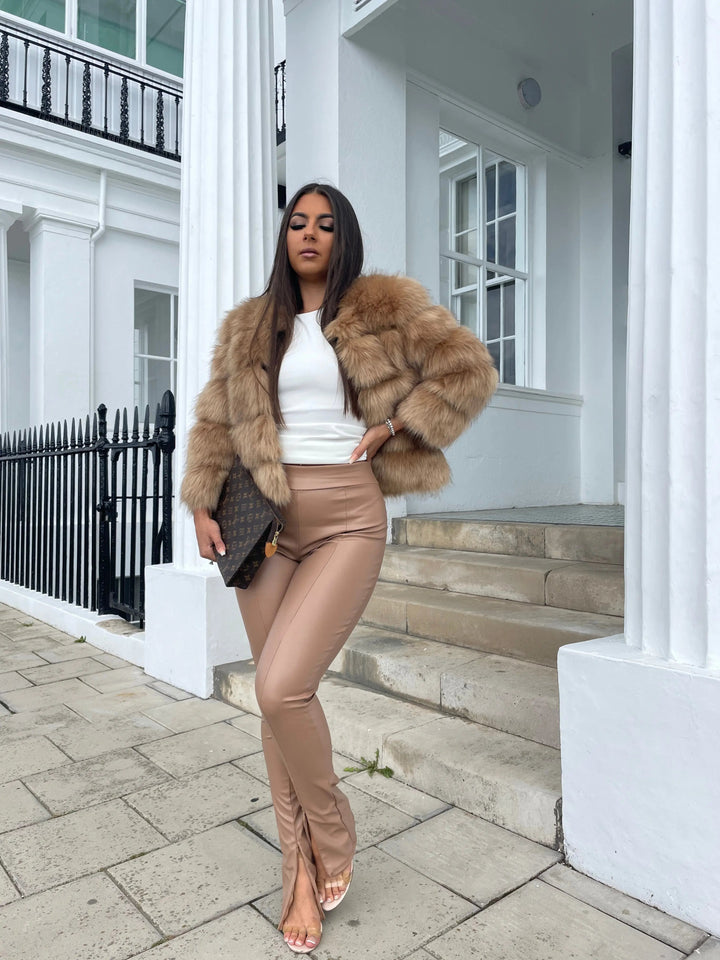 Women's warm and elegant faux fur jacket, a cold weather fashion essential.