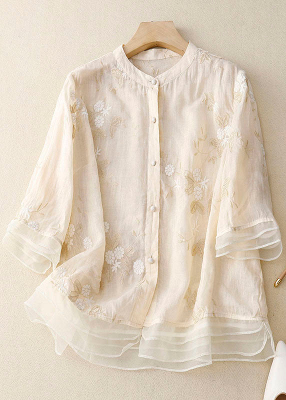 Close-up of delicate floral pattern on a women's 3/4 sleeve button-down blouse, ideal for spring fashion.