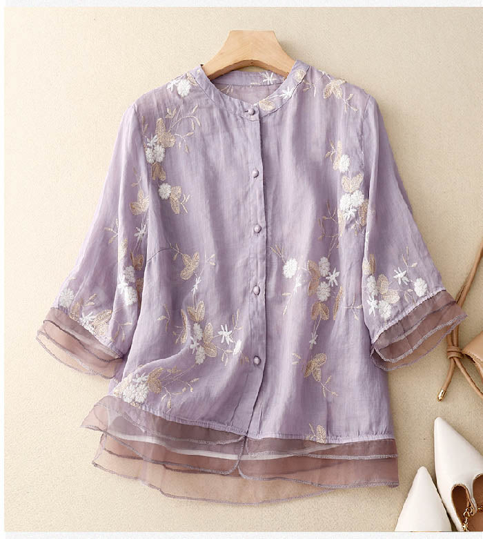 Detail of the button-down front and collar on a stylish women's floral 3/4 sleeve blouse. Versatile top.