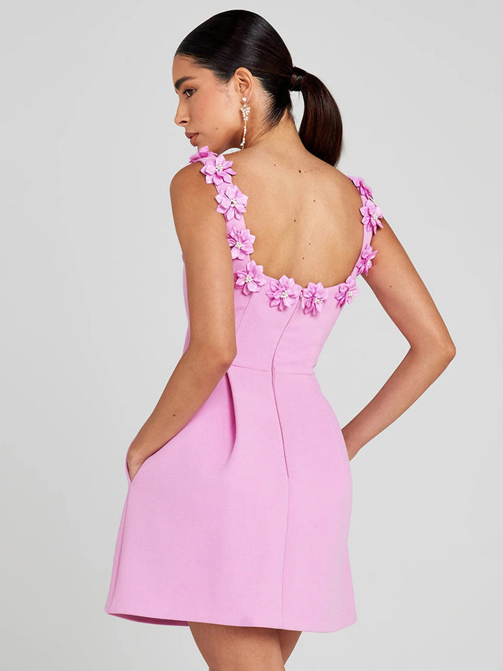 Structured women's mini dress with intricate floral embellishments, ideal for special occasions.