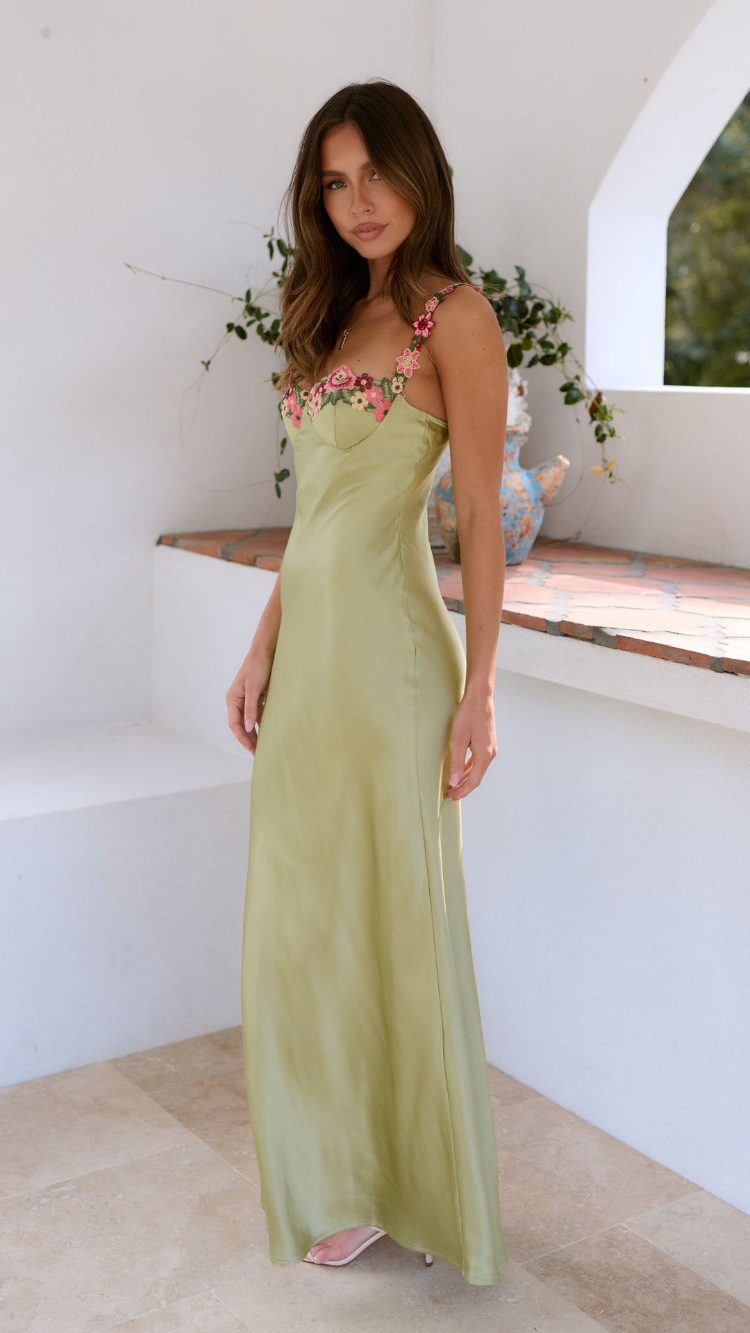 Elegant women's evening maxi dress featuring beautiful floral embroidery and a flowing design.