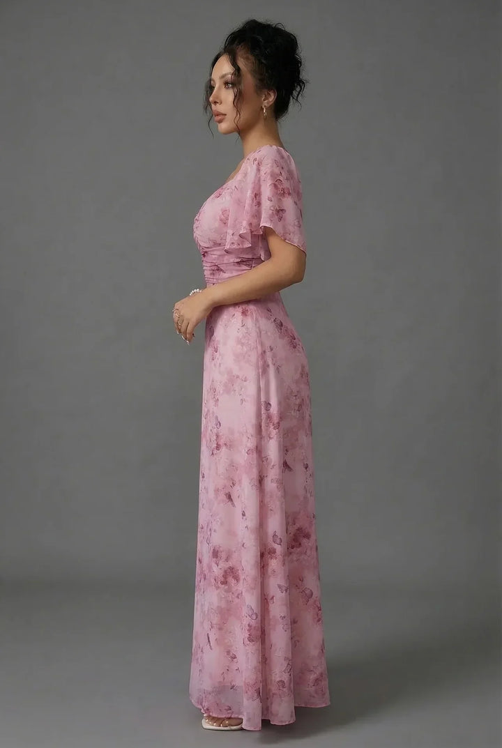 Romantic floral maxi dress for women featuring flutter sleeves & sweetheart neckline, ideal for wedding guests.
