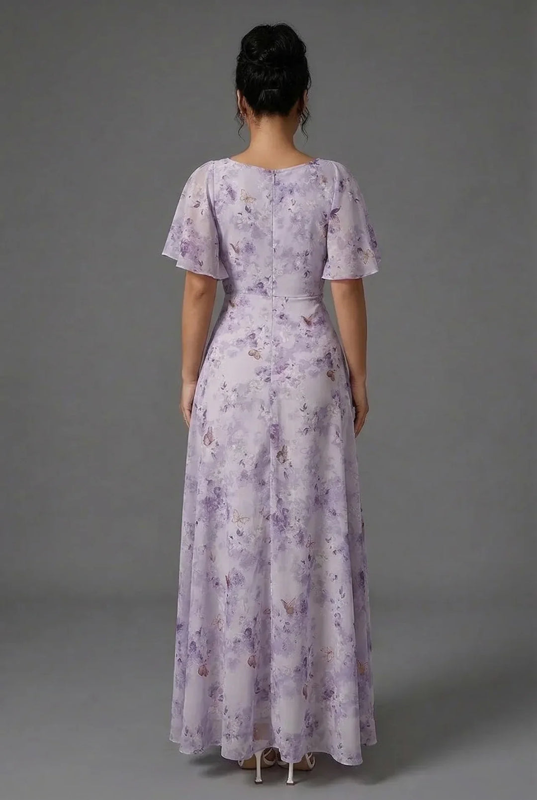 Vibrant women's floral maxi dress, featuring romantic flutter sleeves, ideal for spring & summer fashion.