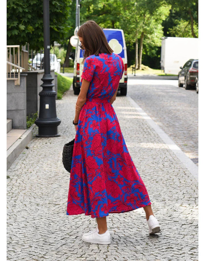 Vibrant floral print maxi dress for women, featuring a stylish V-neck and relaxed fit, ideal for spring/summer.