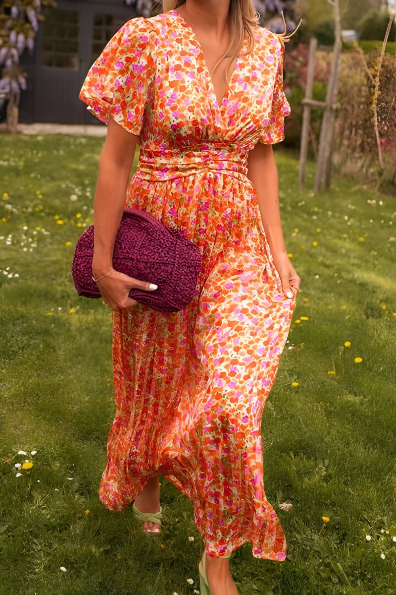 Flowy floral maxi dress for women, featuring a flattering V-neck and short sleeves. Ideal for summer casual wear.
