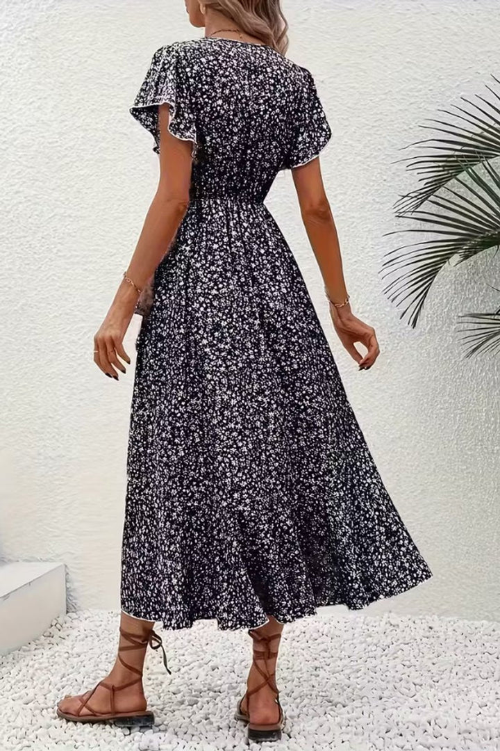 Delicate flutter-sleeve floral midi wrap dress, perfect for any elegant summer gathering.