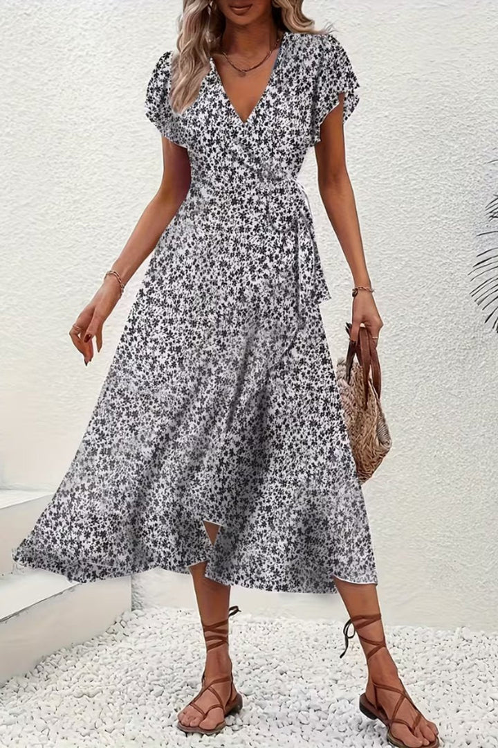 Summer floral wrap midi dress with flutter sleeves, ideal for garden parties and elegant outings.