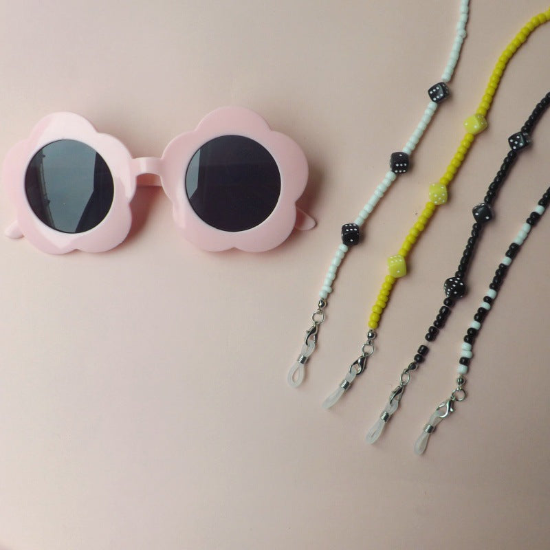 Women's elegant flower sunglasses with stylish beaded strap, offering UV protection for summer.