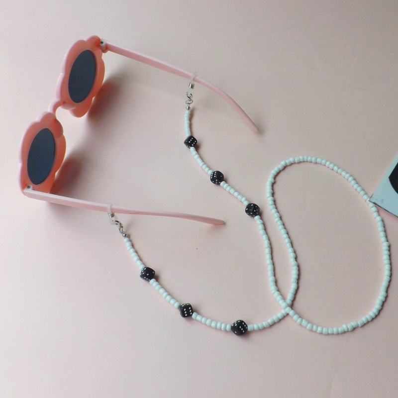 Elegant women's flower sunglasses, featuring a unique beaded strap & UV protection for stylish summer wear.