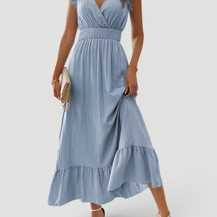 Graceful women's flowy V-neck maxi dress with ruffles, ideal for elegant summer evenings & vacations.