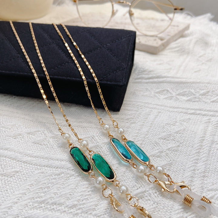 Women's elegant gemstone pendant necklace with delicate pearls, a sophisticated fashion accessory.