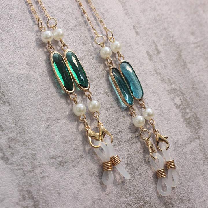 Close-up of elegant women's gemstone pendant necklace, intricate design with lustrous pearls.