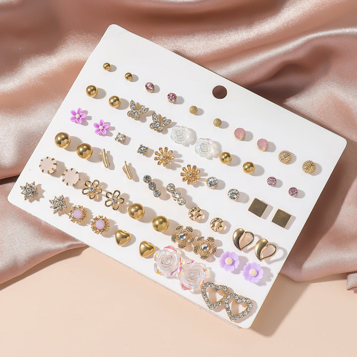 Women's elegant gold accent earring set with sparkling rhinestones. Versatile fashion jewelry accessory.
