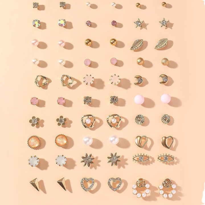 Elegant women's gold earrings with delicate rhinestone accents. Versatile jewelry set for modern fashion.