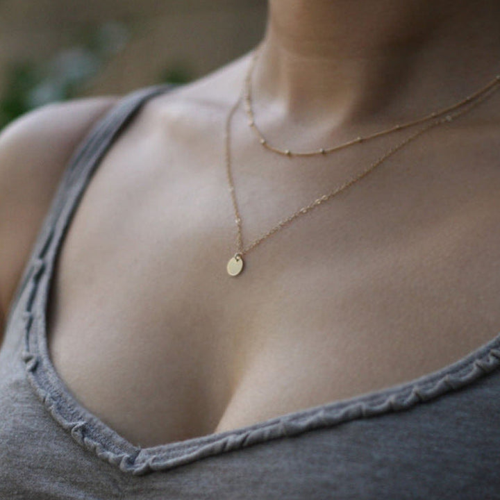 Women's elegant gold layered chain necklace. Delicate, sophisticated jewelry for a stylish statement.