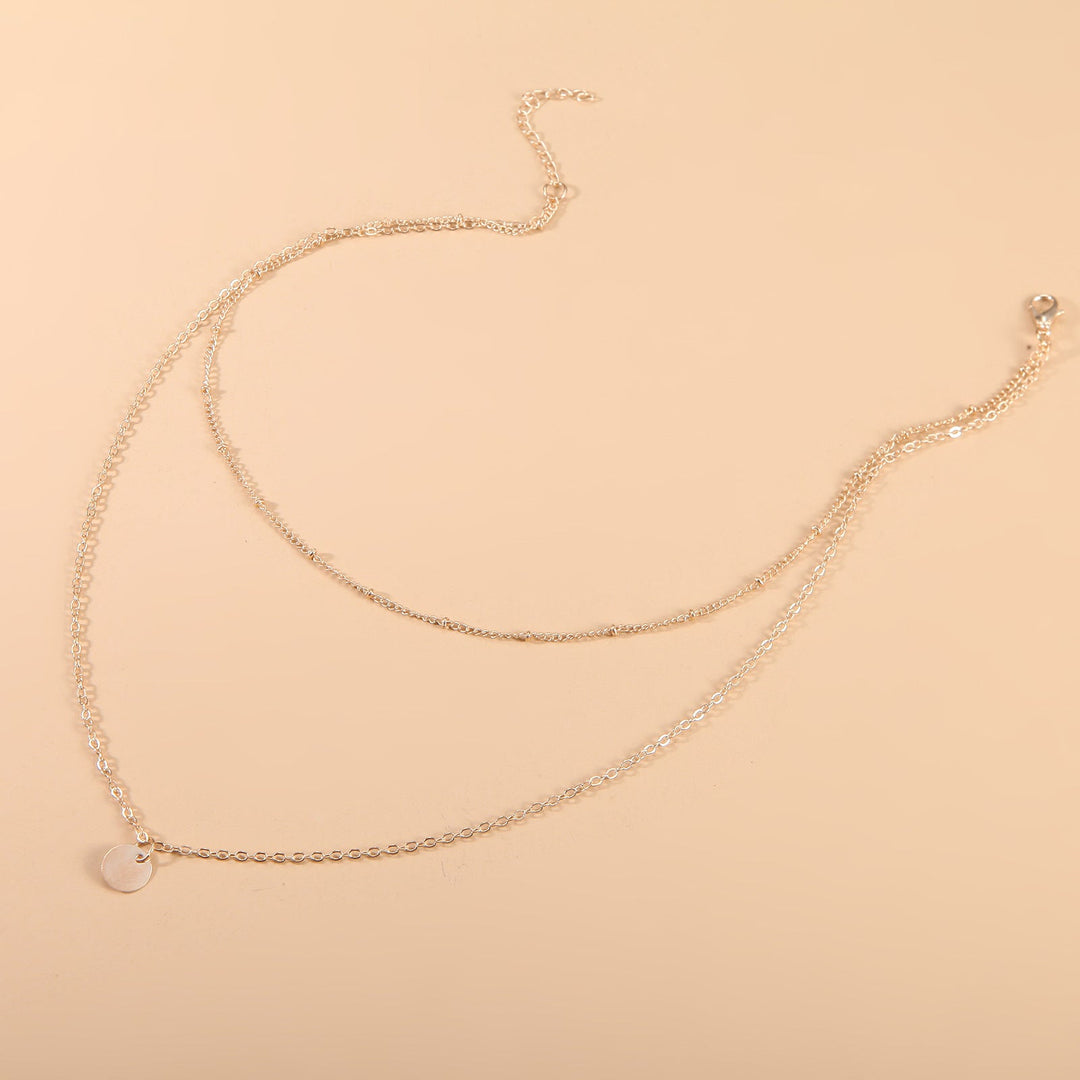 Delicate gold layered chain necklace for women. Elegant, versatile jewelry, perfect as a fashion statement.