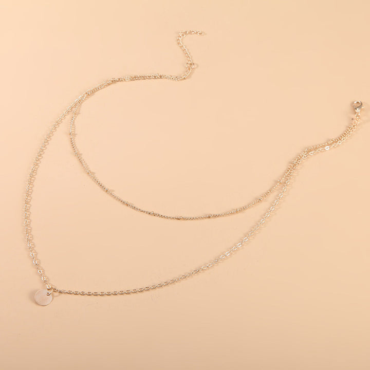 Delicate gold layered chain necklace for women. Elegant, versatile jewelry, perfect as a fashion statement.