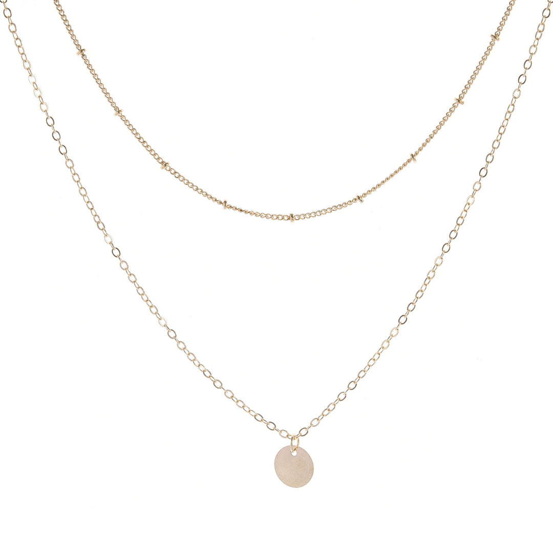 Chic gold layered chain necklace for women. Elegant and modern jewelry, a delicate accessory for everyday wear.