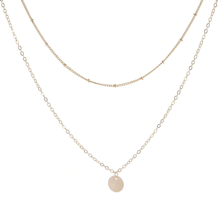 Chic gold layered chain necklace for women. Elegant and modern jewelry, a delicate accessory for everyday wear.