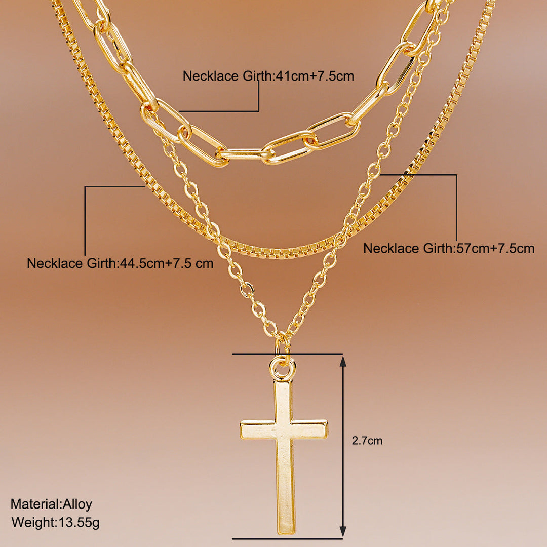 Stylish women's multi-layered gold necklace featuring a delicate cross pendant. Modern spiritual fashion jewelry.
