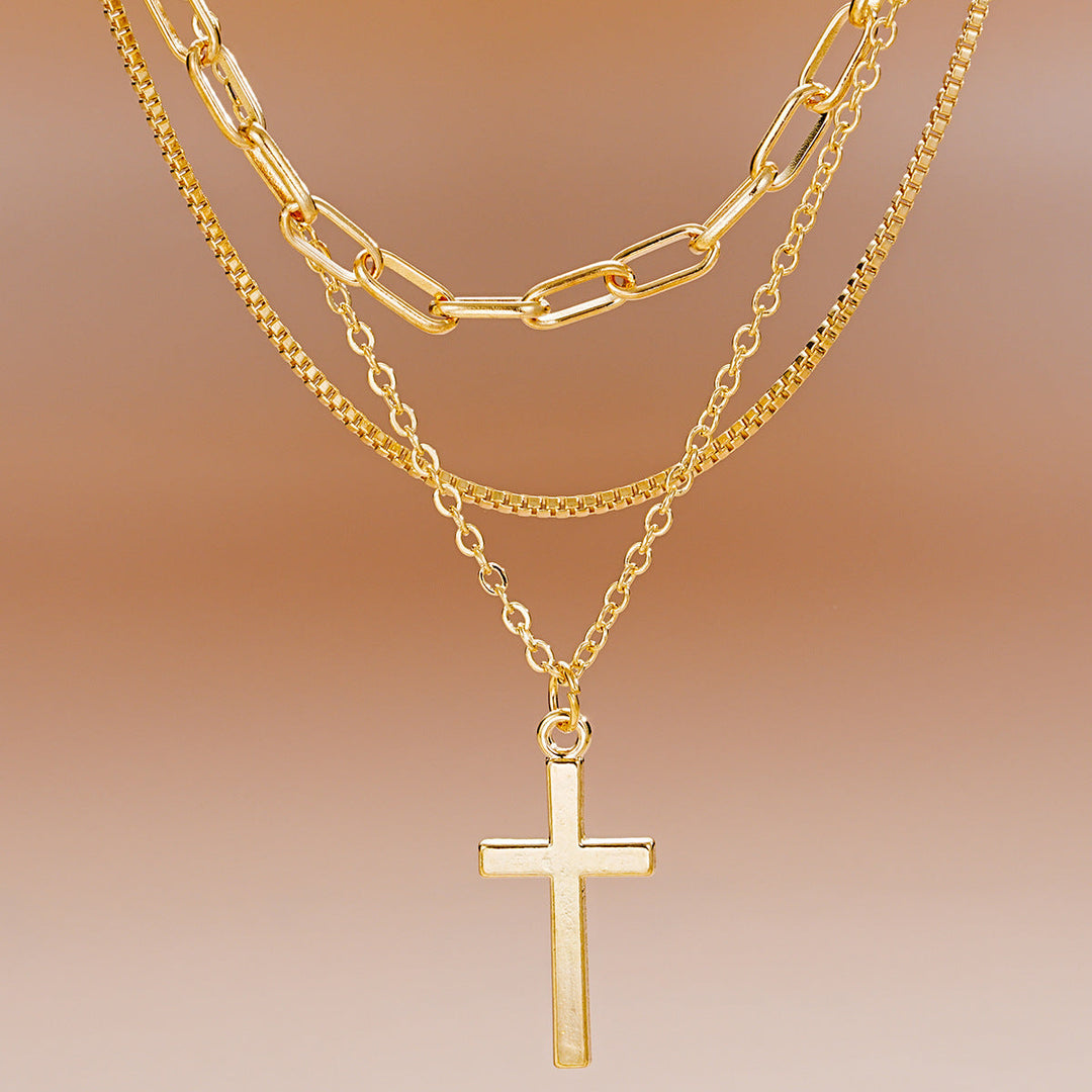 Versatile gold multi-layered cross pendant necklace for women. Perfect for daily wear or elegant occasions.