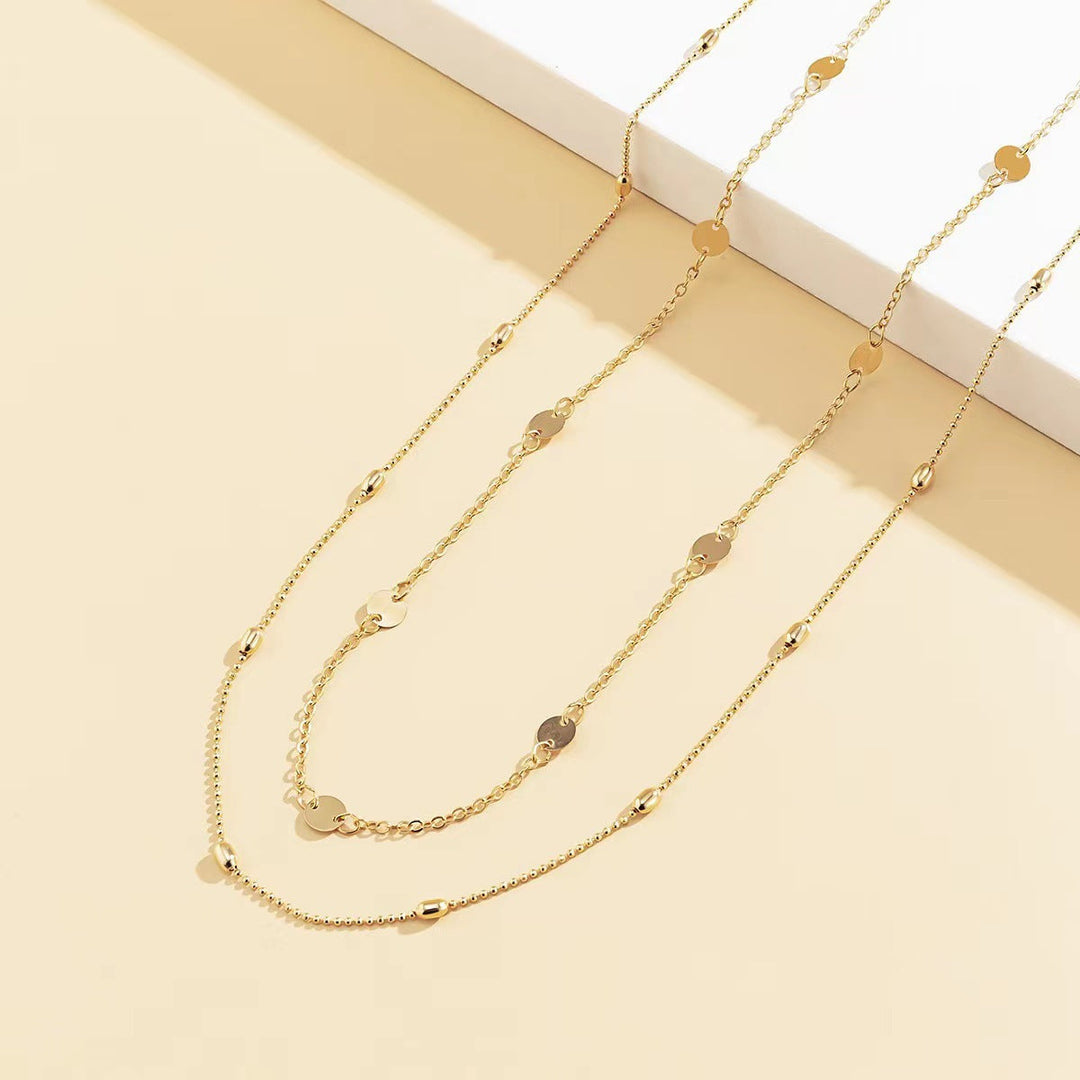 Stylish women's layered charm necklace in gold, a versatile fashion jewelry piece.