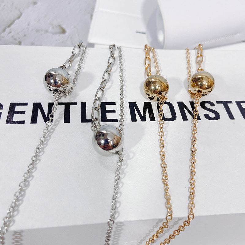 Chic gold-tone pendant necklace for women, modern design perfect as an elegant accessory or statement piece.