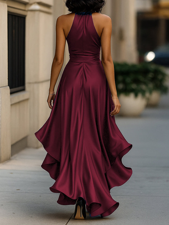 Close-up of the luxurious fabric of a women's halter ruffle high-low evening gown.