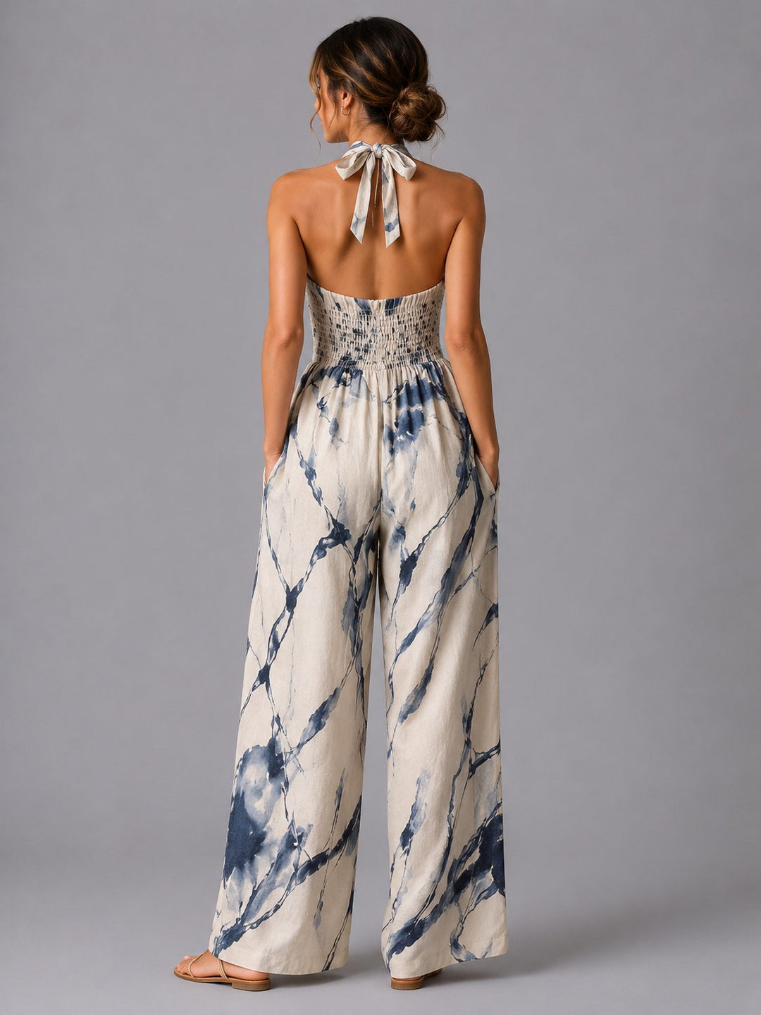 Blue women's halterneck wide-leg jumpsuit, comfortable and stylish for casual summer fashion or vacation.