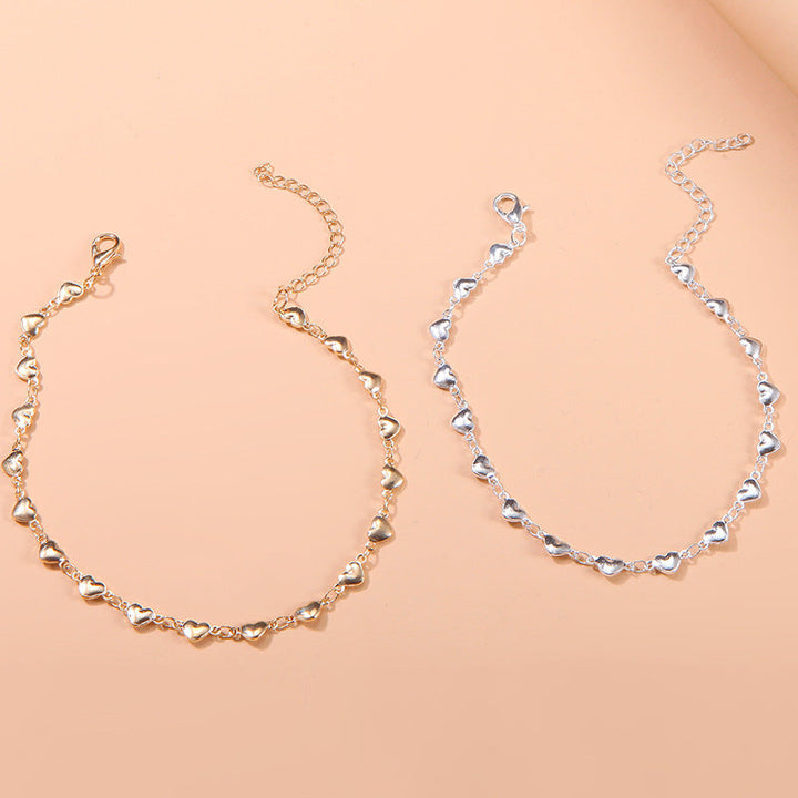 Dainty gold chain anklet for women with a delicate heart charm, adjustable summer accessory.
