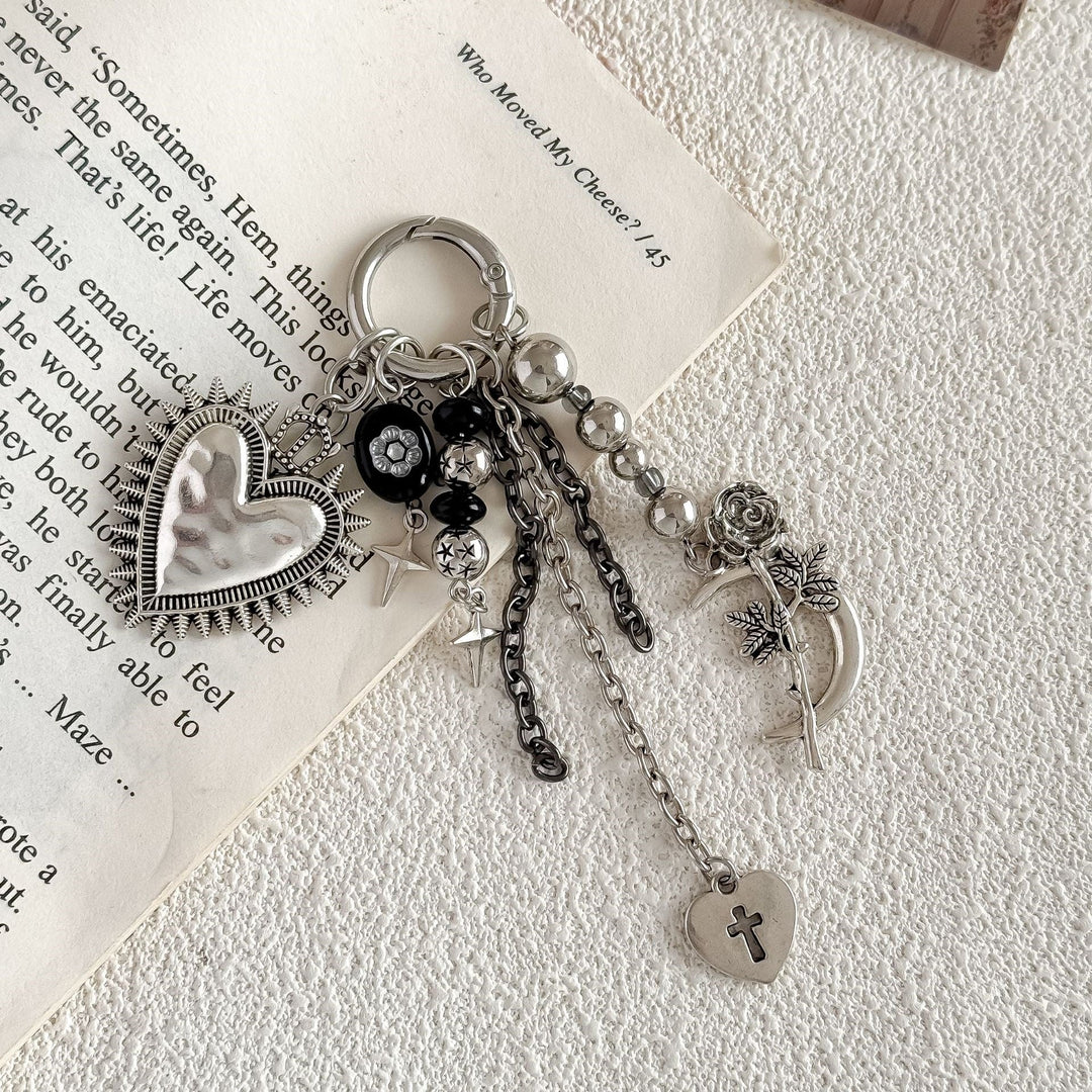 Delicate gold-tone women's keyring with heart & floral charms, elegant accessory for bags.