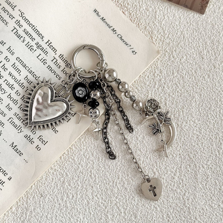Delicate gold-tone women's keyring with heart & floral charms, elegant accessory for bags.