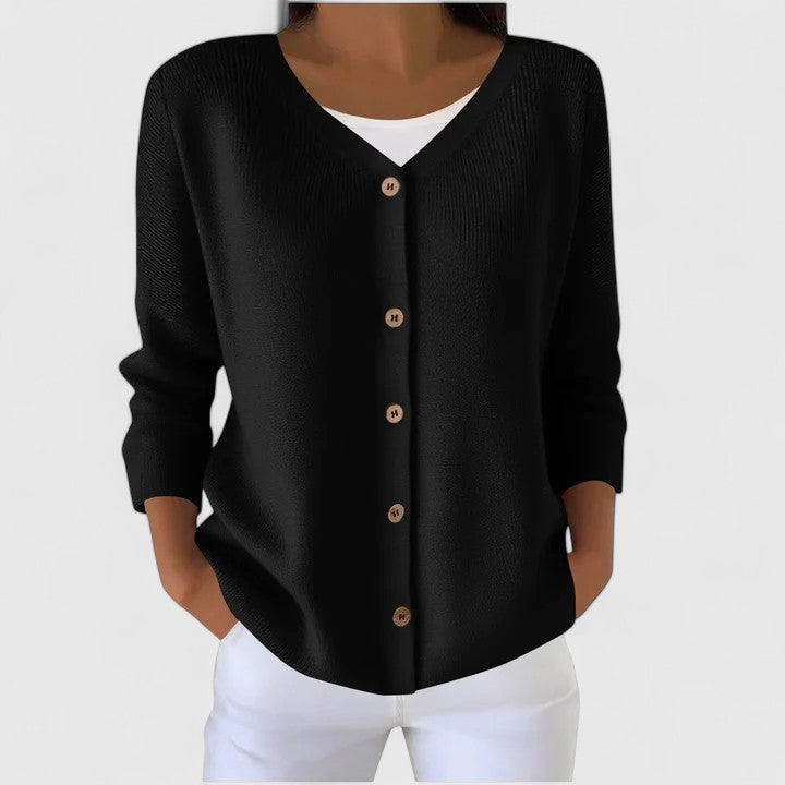 Woman in relaxed fit hooded cardigan, long sleeve, showcasing elegant and cozy everyday style.